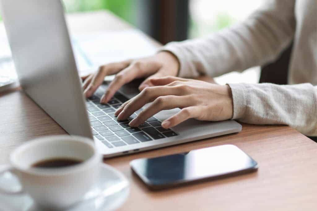 Person working on a laptop for web design or development.